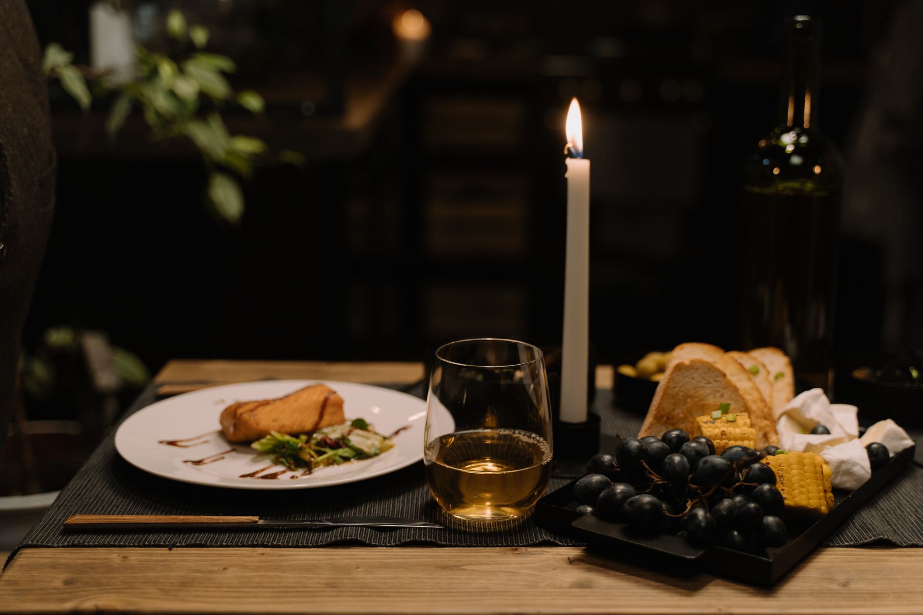 A wine glass catching candlelight